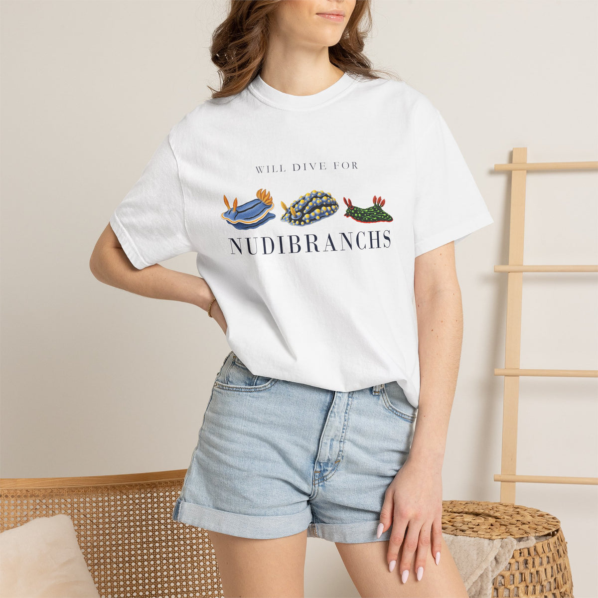 White Will Dive for Nudibranchs tee on a model with a hand on her hip, denim shorts