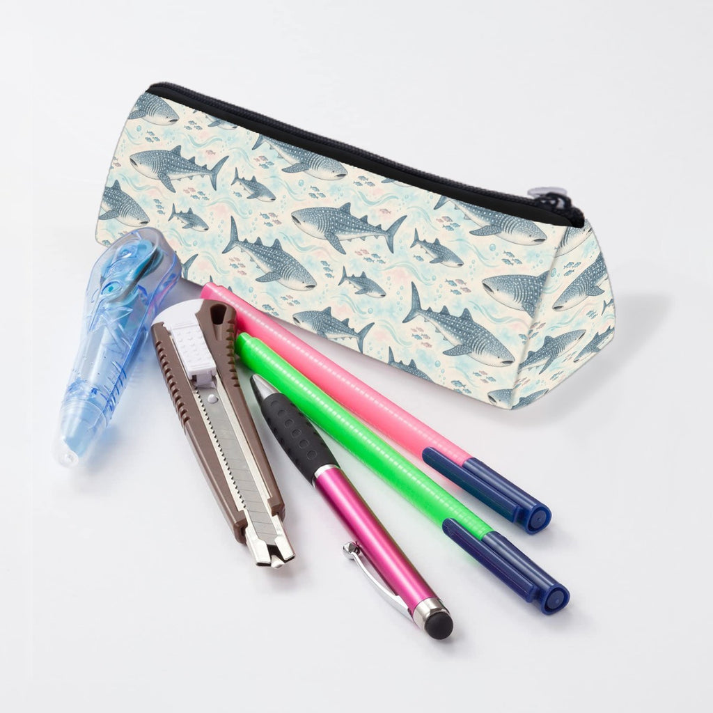 Whale shark and shark pencil case lying beside pens and markers