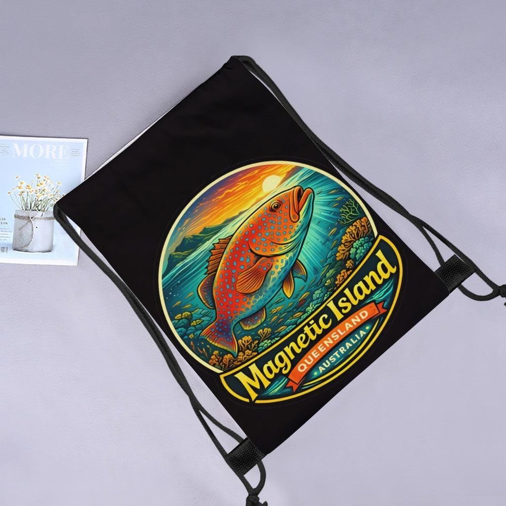Coral trout Magnetic Island drawstring bag laid flat next to a magazine and flowers.