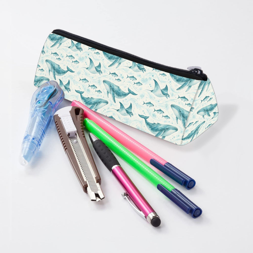 Whale and ray pencil case lying beside pens and markers