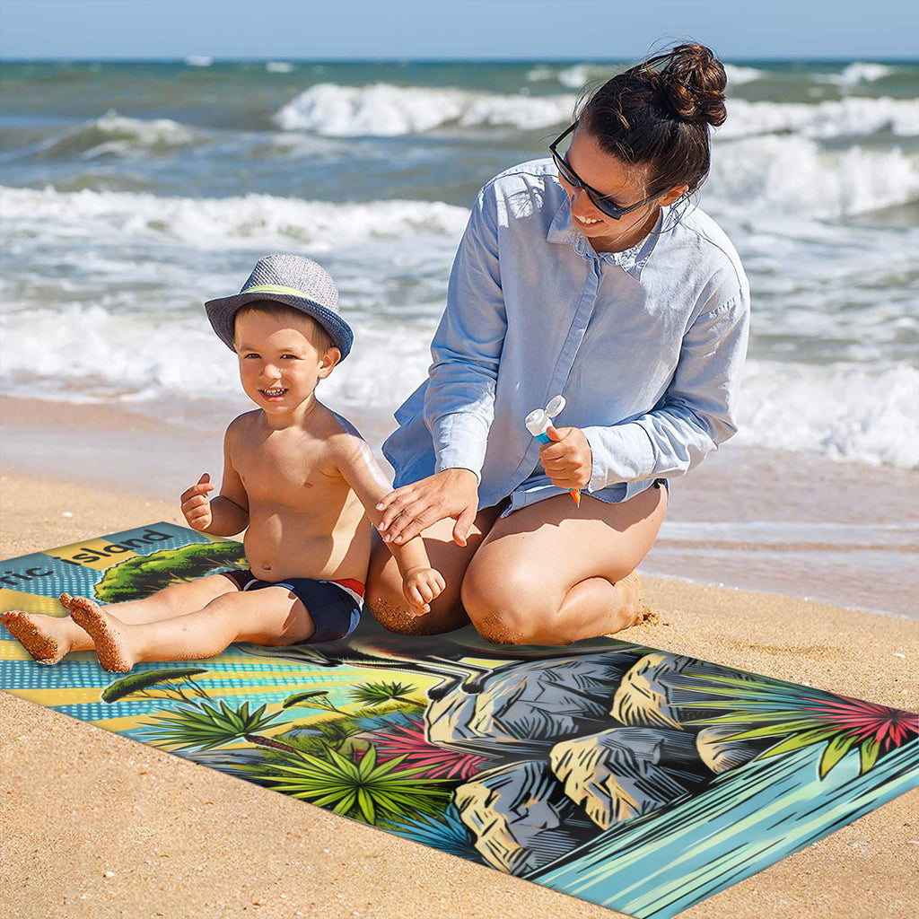 Family on the sand with the kangaroo beach towel laid out
