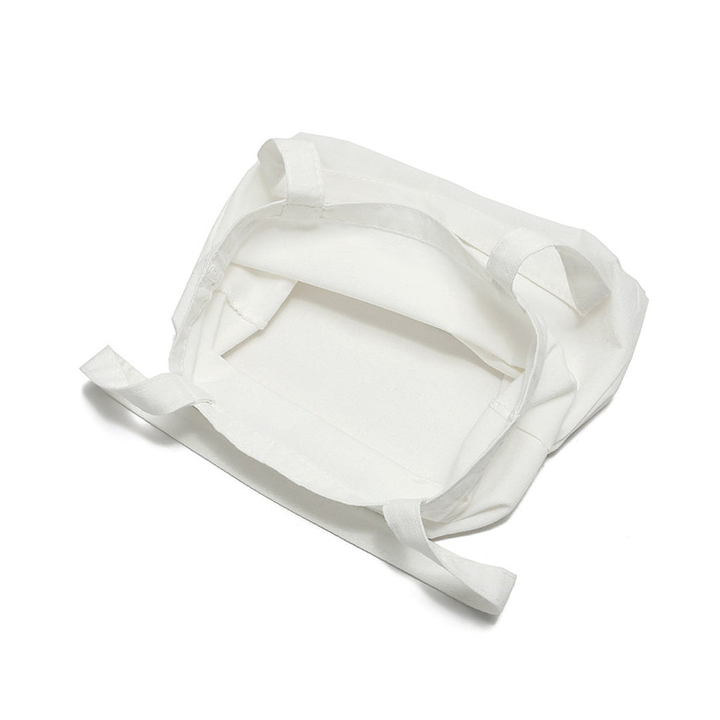 Blank canvas tote bag construction, showing the handles and lining