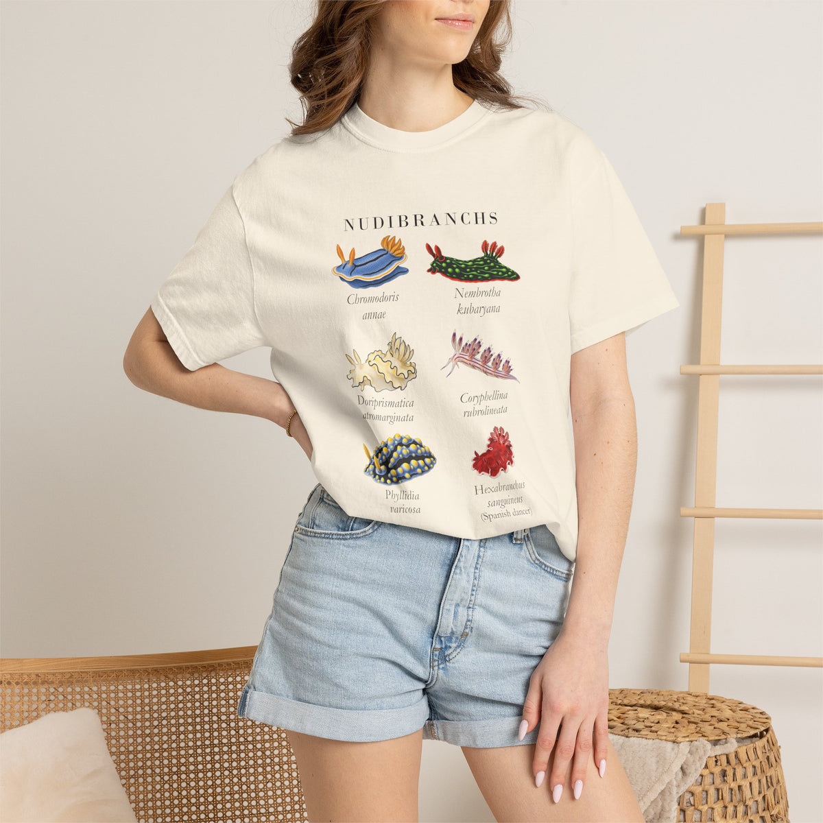 Ivory nudibranch plate tee on a model with a hand on her hip, denim shorts, front view