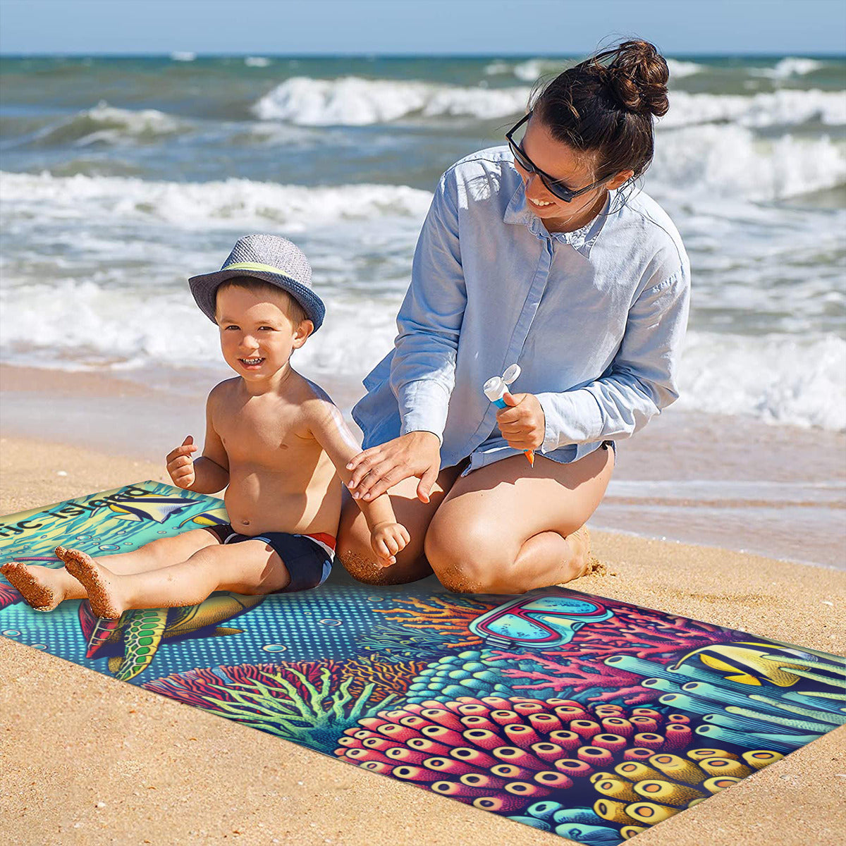 Family on the sand with the snorkelling turtle beach towel laid out