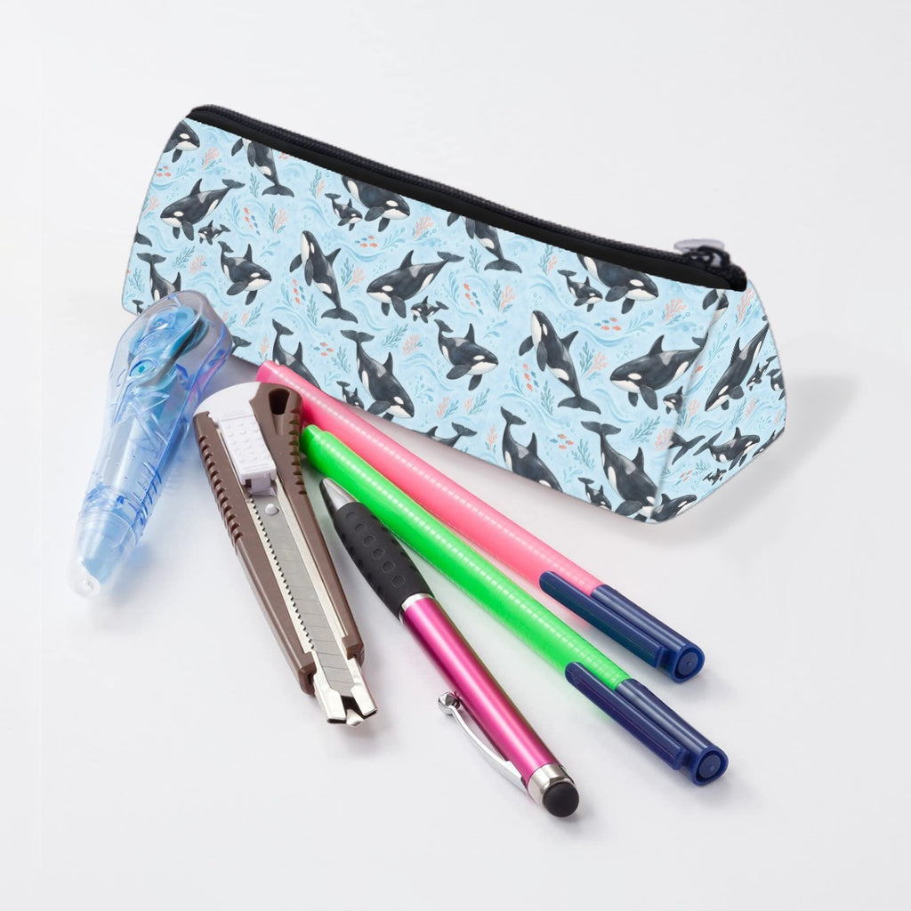 Orca pencil case lying beside pens and markers