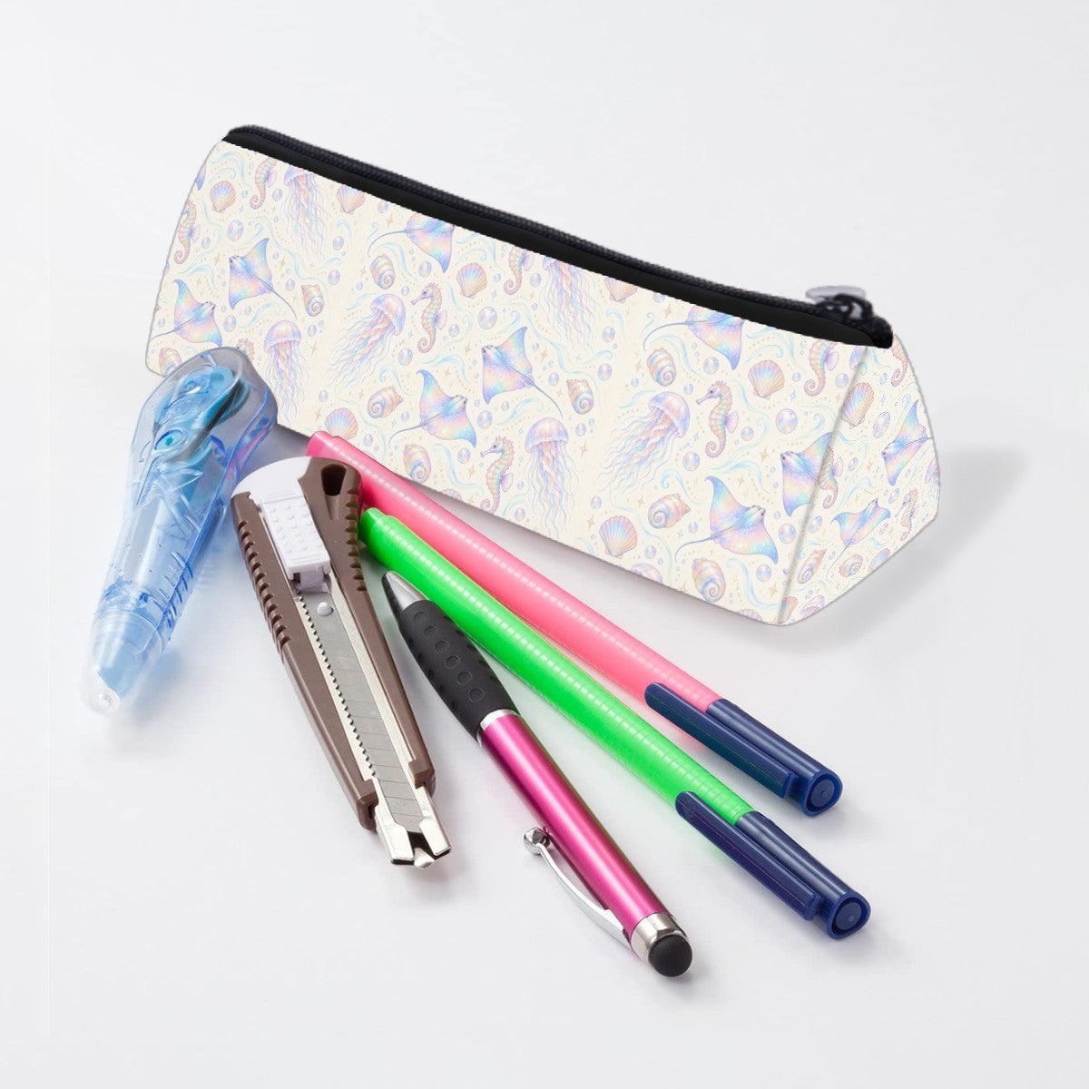 Iridescent ocean pencil case lying beside pens and markers