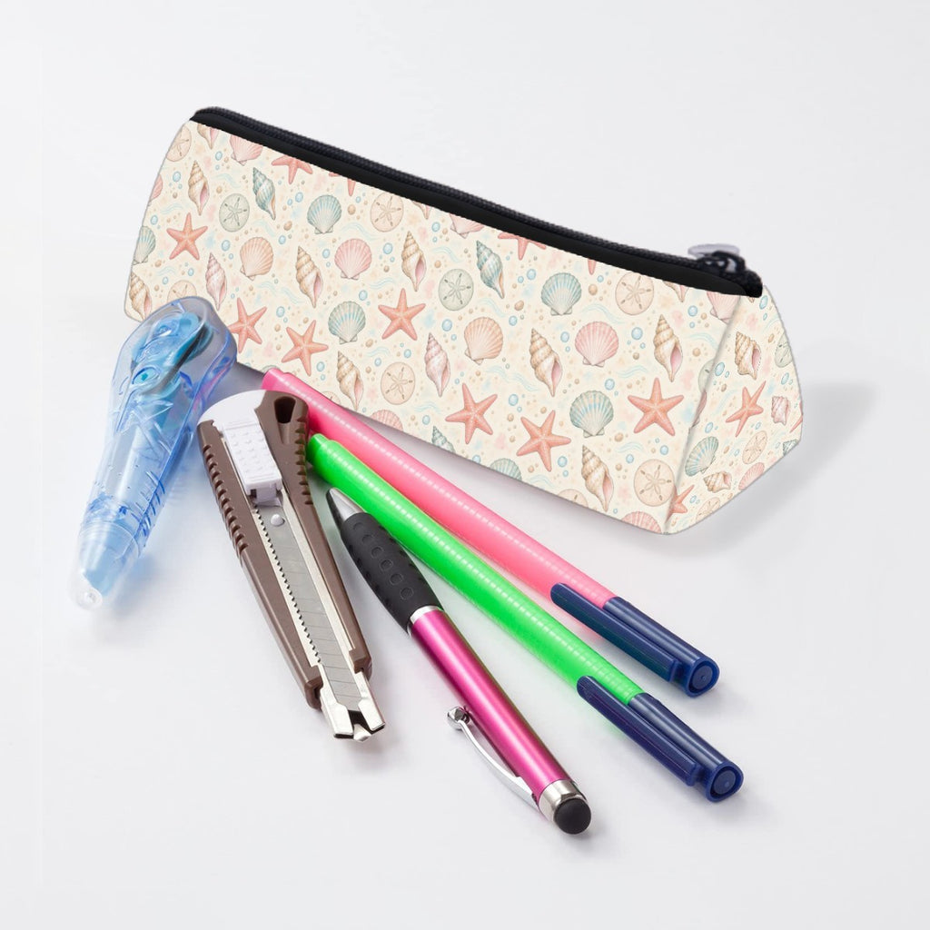 Seashell pencil case lying beside pens and markers
