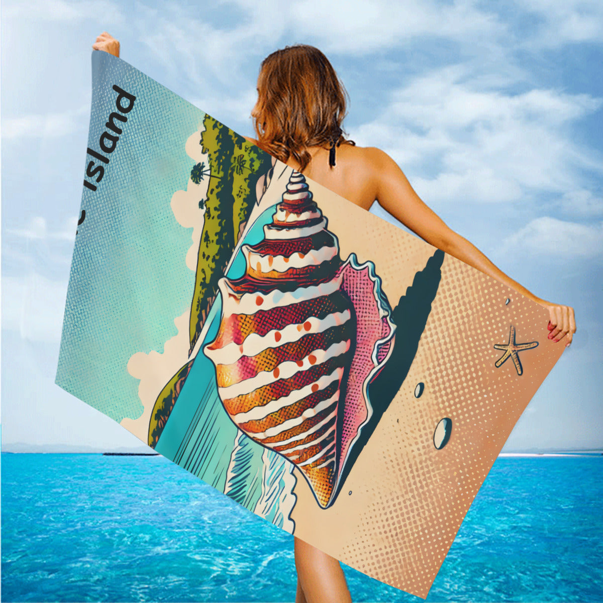 Shell beach towel held up on the beach in the wind