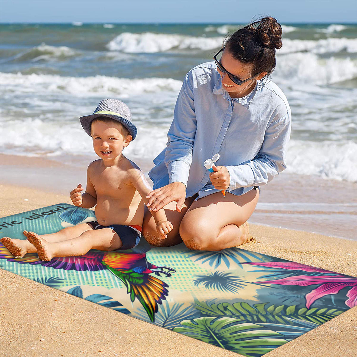 Family on the sand with the rainbow lorikeet beach towel laid out
