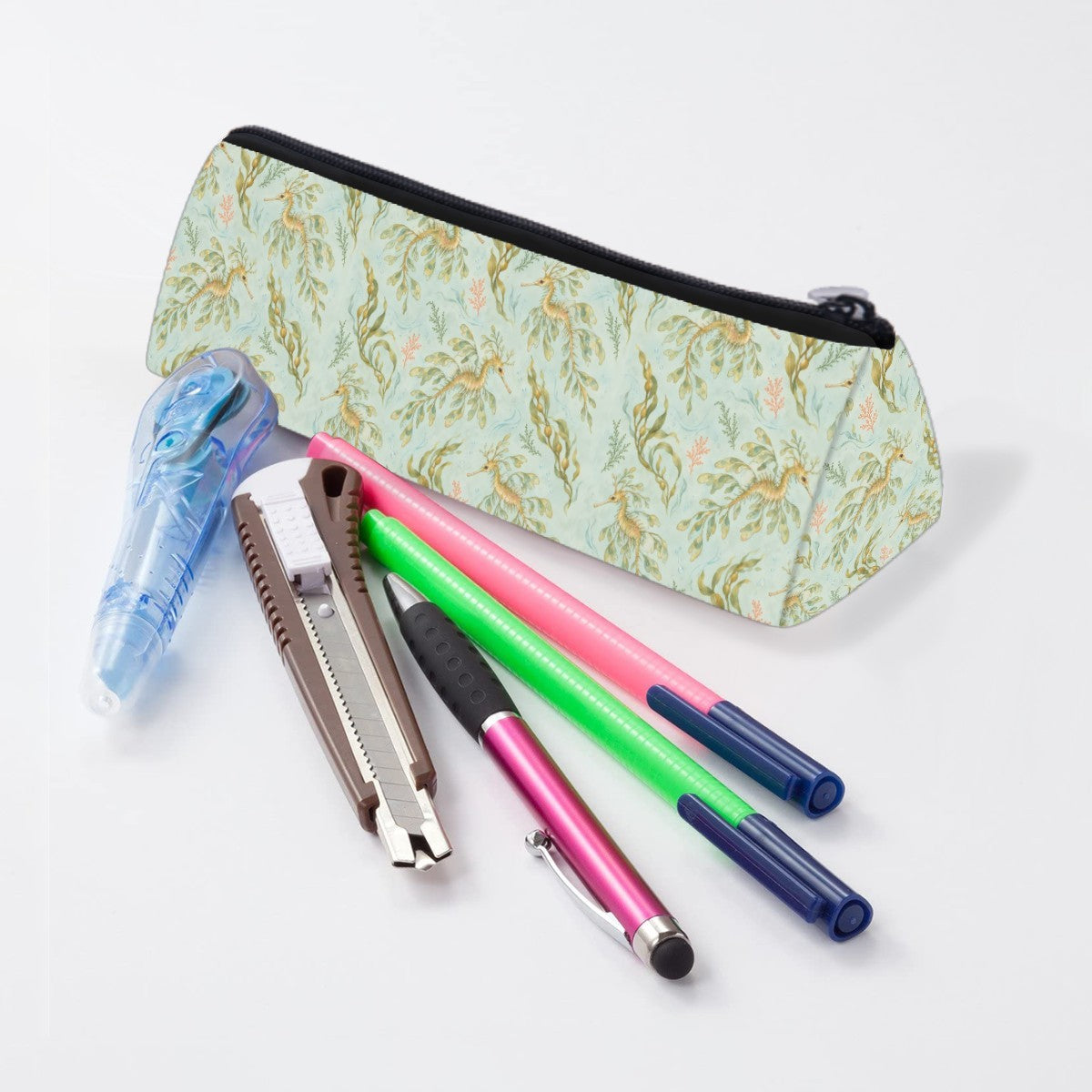 Leafy sea dragon pencil case lying beside pens and markers