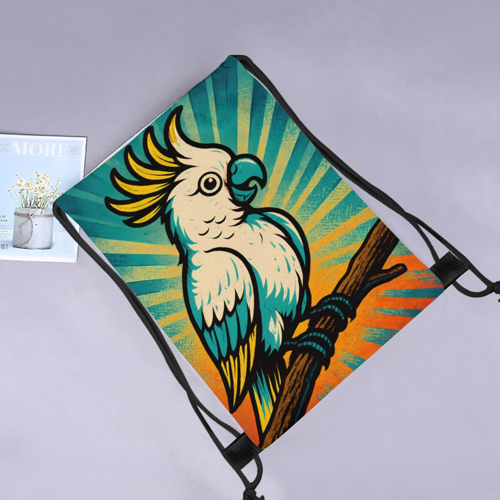 Retro cockatoo drawstring bag laid flat next to a magazine and flowers.