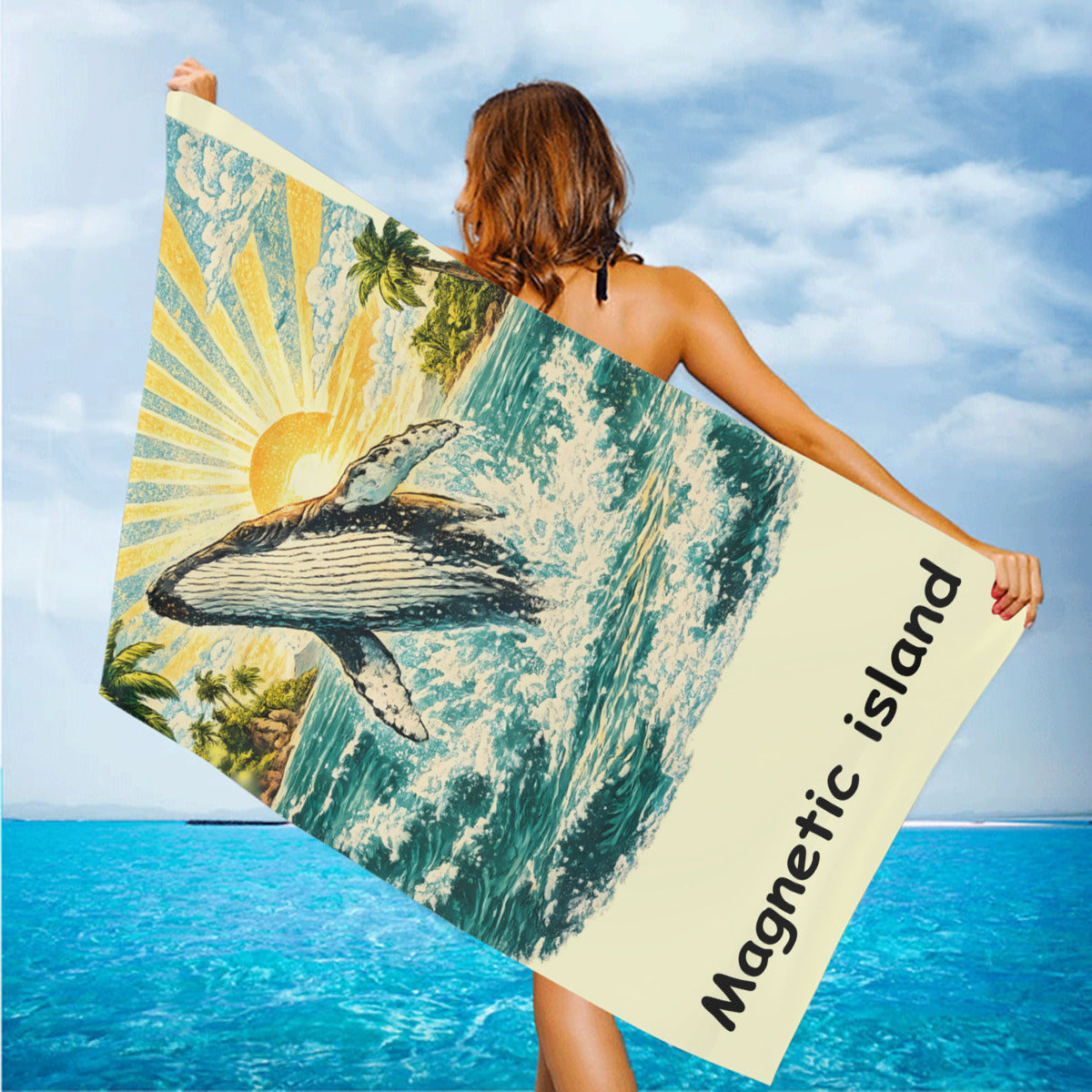 Humpback whale beach towel held up on the beach in the wind