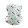Neck gaiter and diving headband with grey and brown pelicans over pale blue waves