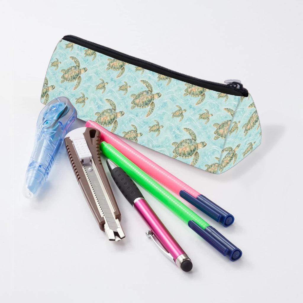 Sea turtle pencil case lying beside pens and markers