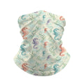 Neck gaiter and diving headband with coral, teal and purple seahorses and seaweed on a cream and pale green background