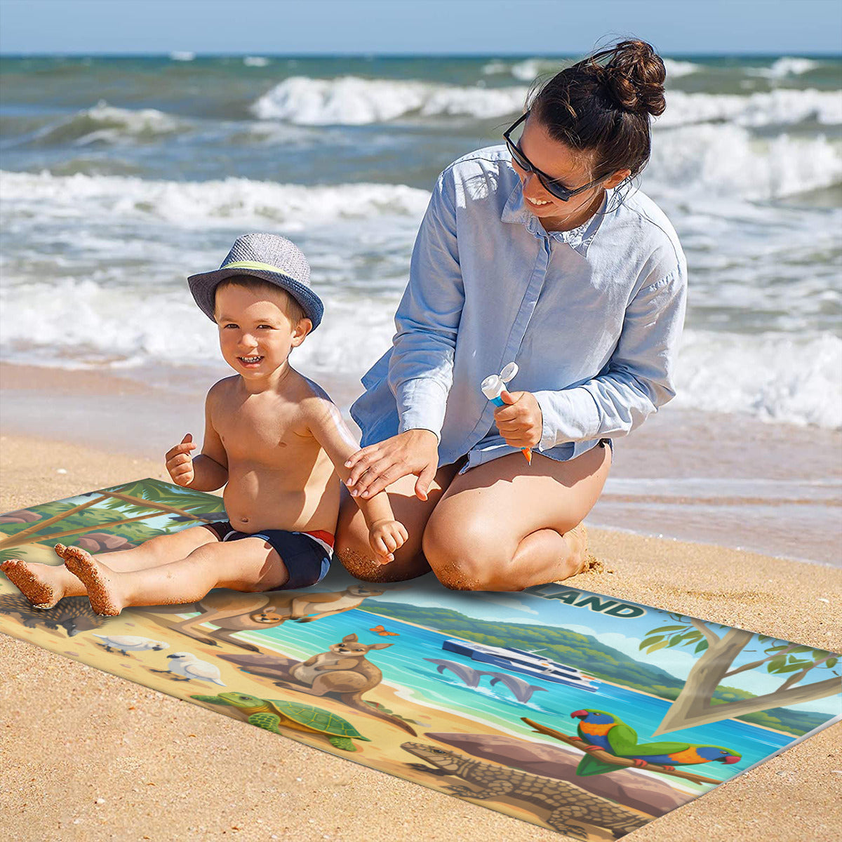 Family on the sand with the Magnetic Island wildlife scene beach towel laid out