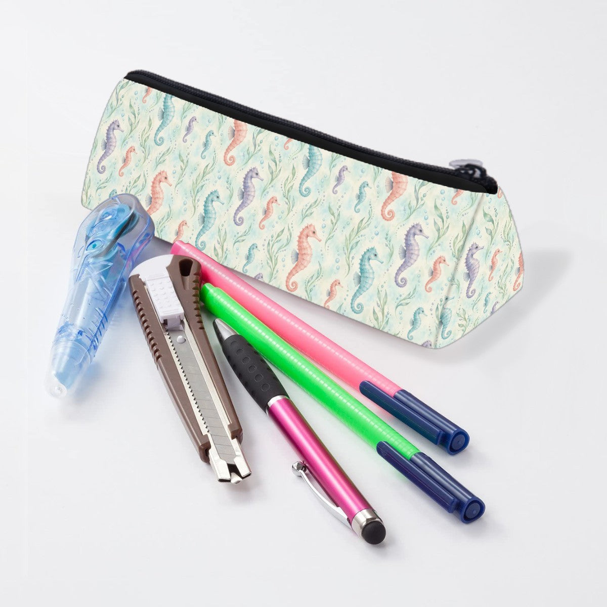 Seahorse pencil case lying beside pens and markers