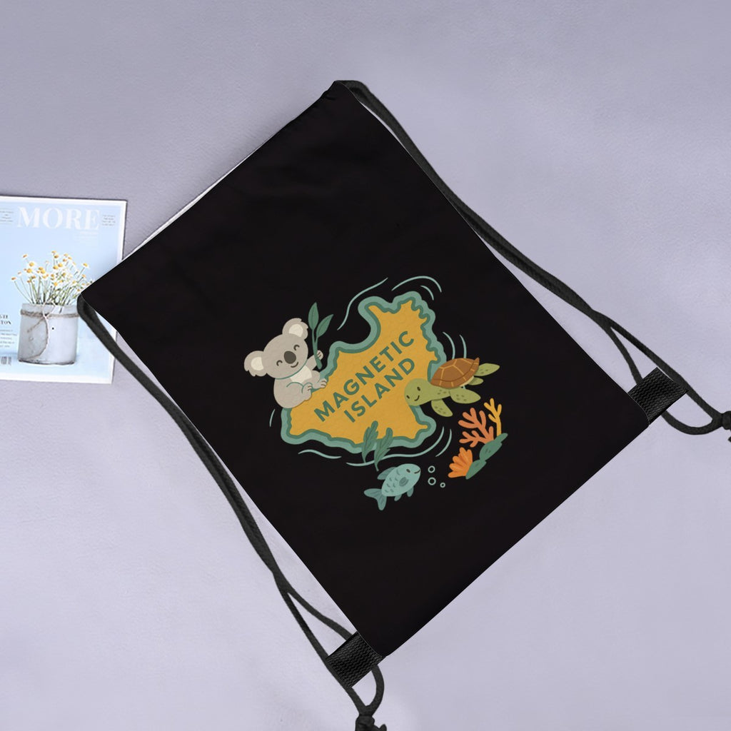 Kids Magnetic Island drawstring bag laid flat next to a magazine and flowers.