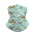 Neck gaiter and diving headband with green sea turtles on aqua water with white wave lines