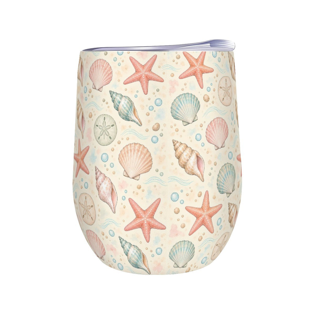 White stemless wine tumbler printed with a repeating pattern of seashells and starfish