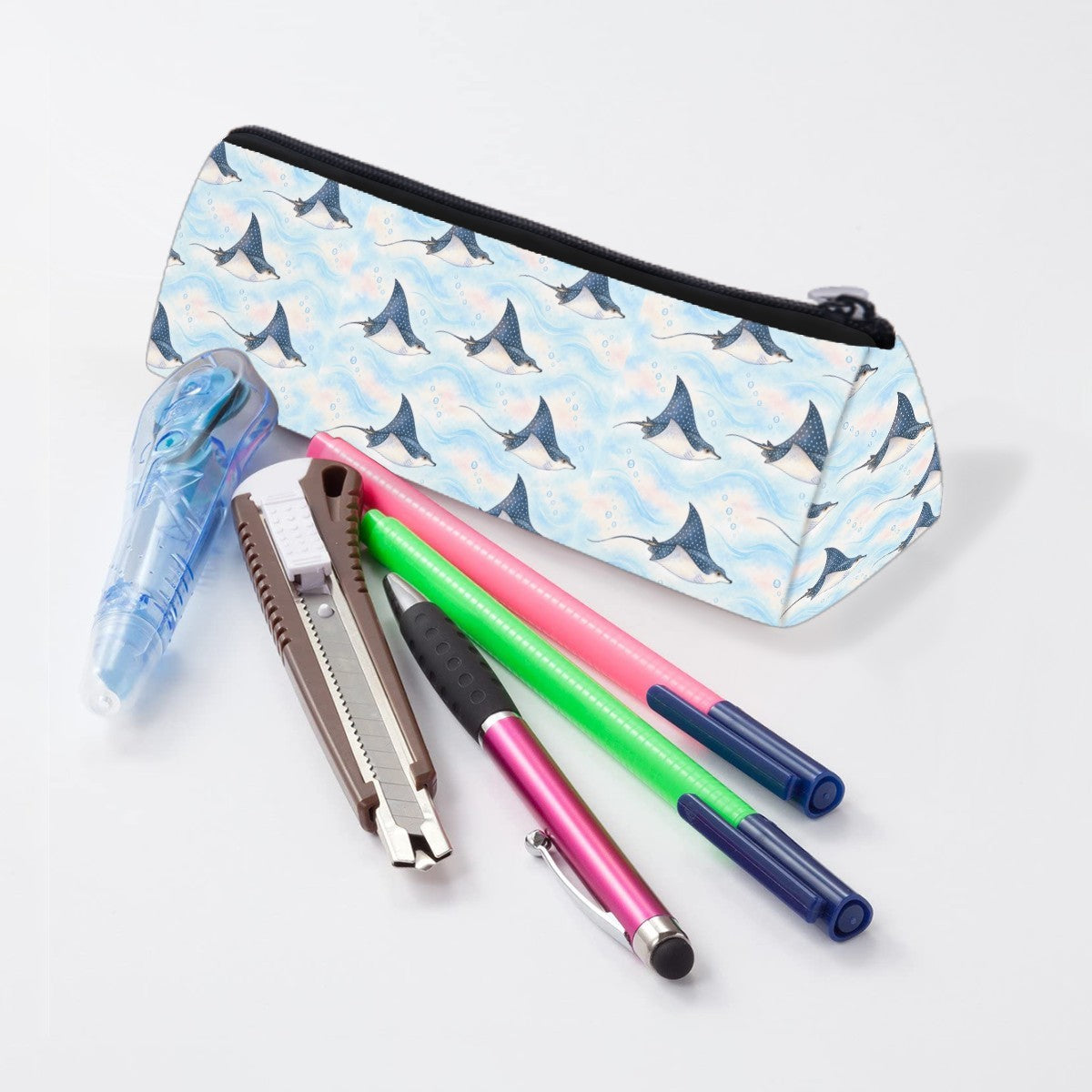 Eagle ray pencil case lying beside pens and markers