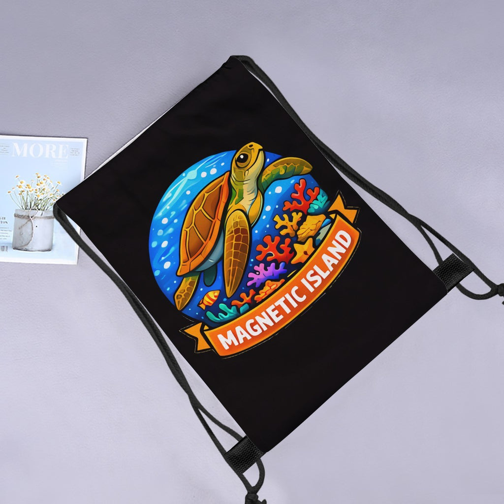 Magnetic Island turtle drawstring bag laid flat next to a magazine and flowers.