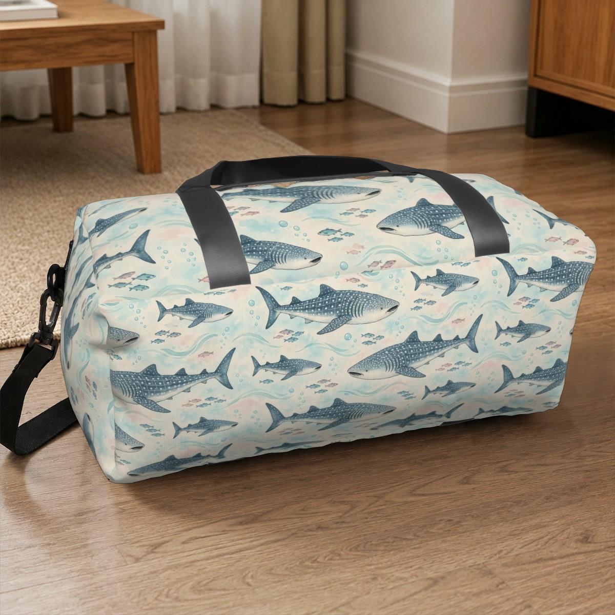 Whale shark duffle bag sitting on a wooden floor beside a table