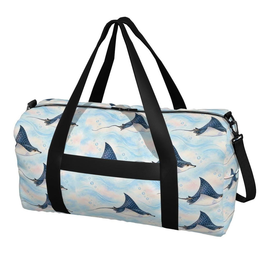 Front of the spotted eagle ray duffle bag showing rays on pale sky blue, with black carry handles