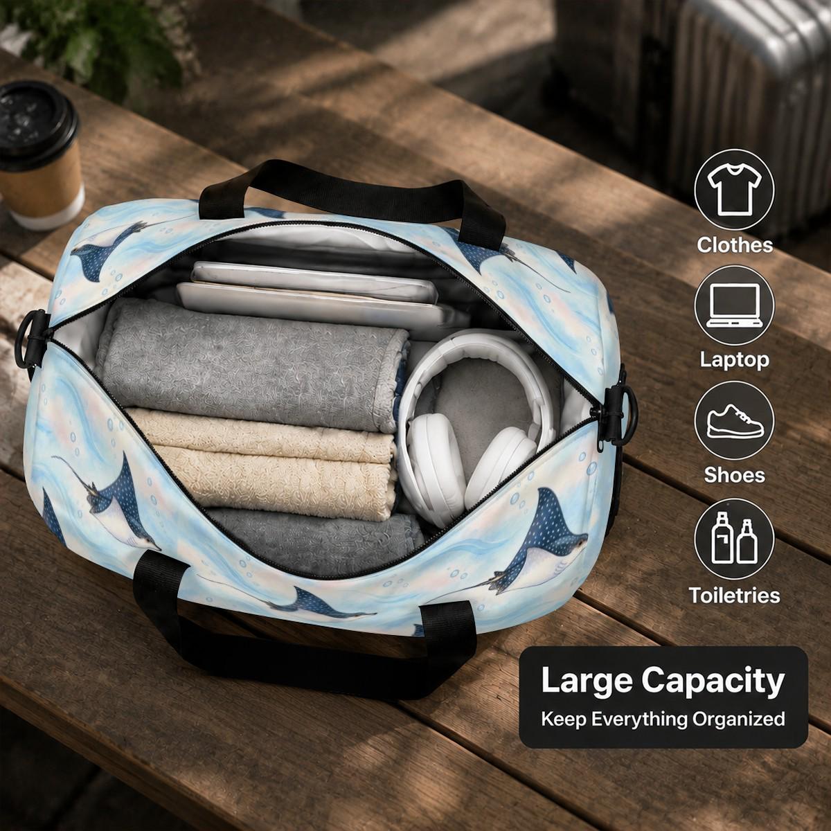 Open spotted eagle ray duffle bag packed with folded clothes and headphones, labelled Large Capacity
